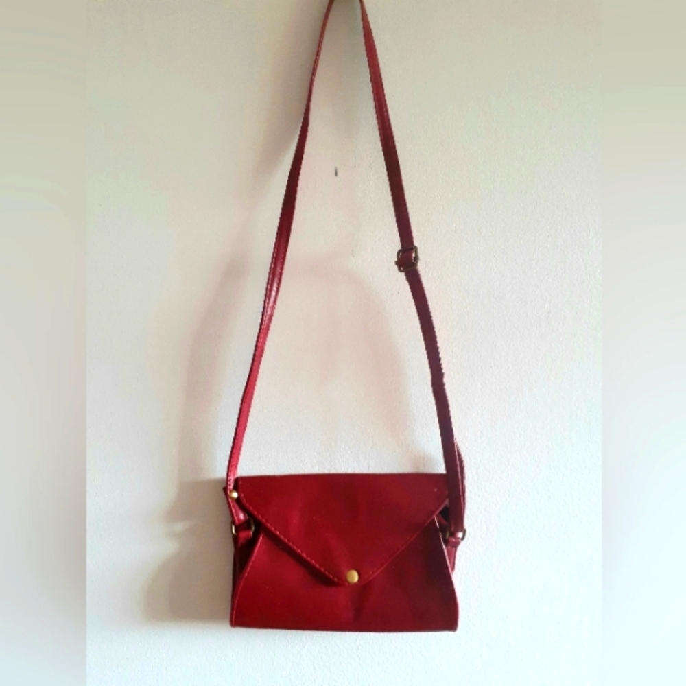 βHOST PICKβ Burgundy leather envelope purse with brass fittings, cross-body bag